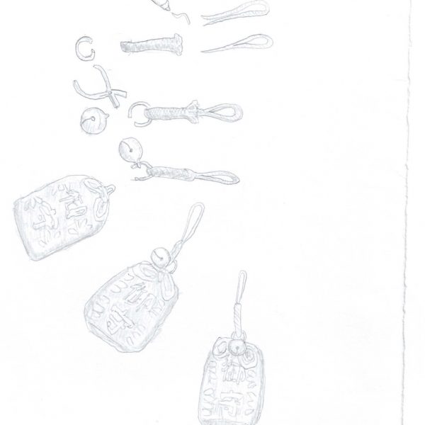 薄い鉛筆による線画で、白い紙の左上から中央にかけて描かれる。上から、長いひも、蝶結び、輪にしたひも数本、小さな金具や鈴、編み上げたストラップの部品が工程を追うように並び、下方には文字の入ったお守り袋が3つ、鈴と編みひもの付いた完成した姿で描かれる。彩色はなく、紙の右側と下半分は余白。